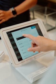 pexels photo 4921264 4921264 Close-up of a hand interacting with a tablet at a checkout counter, illustrating modern retail technology.